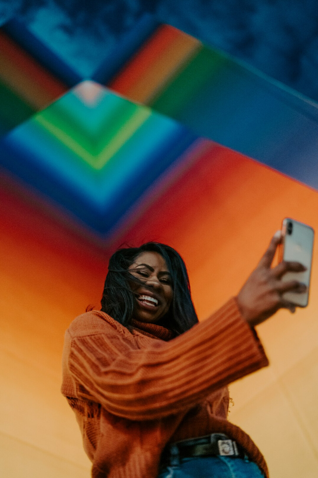 Social media influencer taking a selfie in a stylish outfit