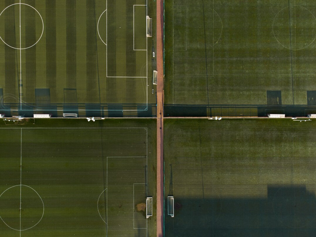 Football star training on a green stadium pitch