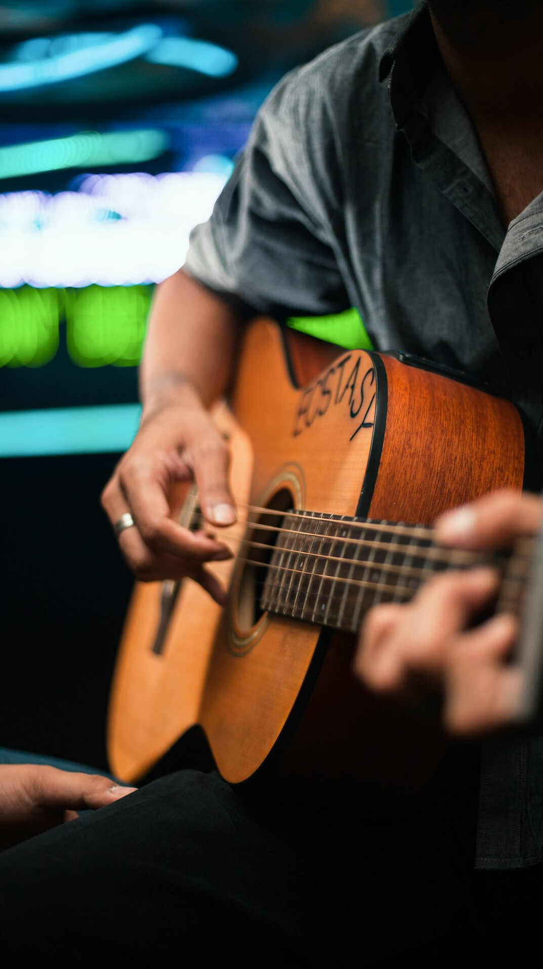 musician playing guitar on stage