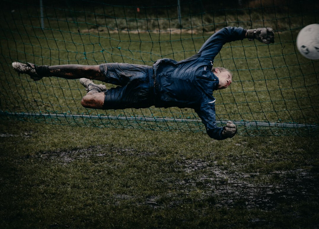 man playing soccer on field