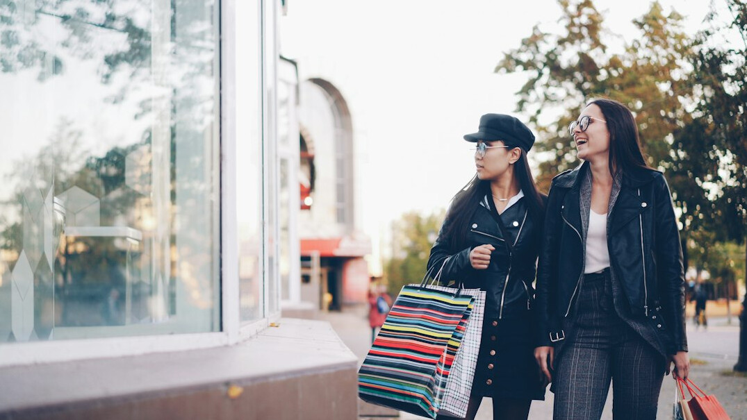 Fashionable woman walking in stylish outfit on city street