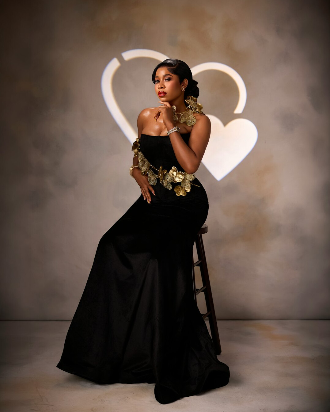 Elegant woman in a glamorous gold dress at a red carpet event