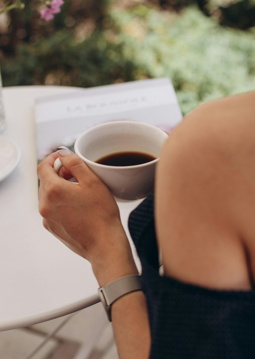 Person checking newsletter emails on a laptop with coffee